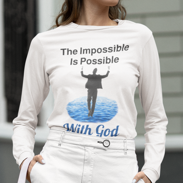Long-sleeve Bella+Canvas t-shirt made from preshrunk ring-spun cotton with “Impossible Man” design message, “The Impossible Is Possible with God,” inspirational apparel calling believers to step out in faith and trust God for more than they can ask or imagine, woman wearing white long-sleeve t-shirt